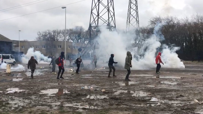 File photo shows French police firing tear gas at refugees in Calais