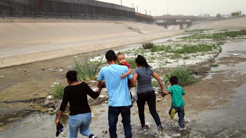 Migrants passing through the Rio Grande River from Mexico into the United States