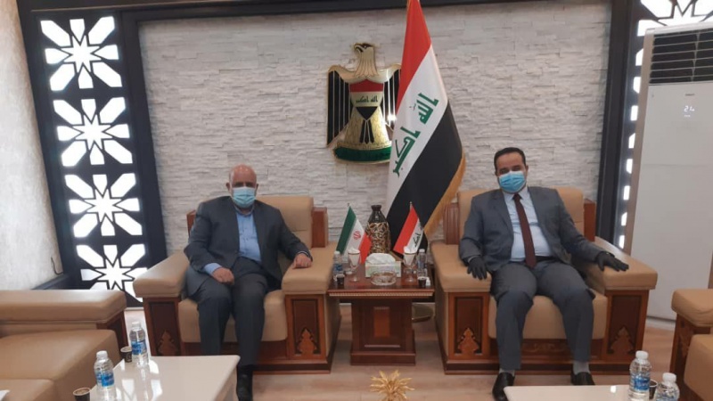 Iran Ambassador to Baghdad Iraj Masjedi Iraqi Minister of trade Alaa Ahmad Hassan Obaid